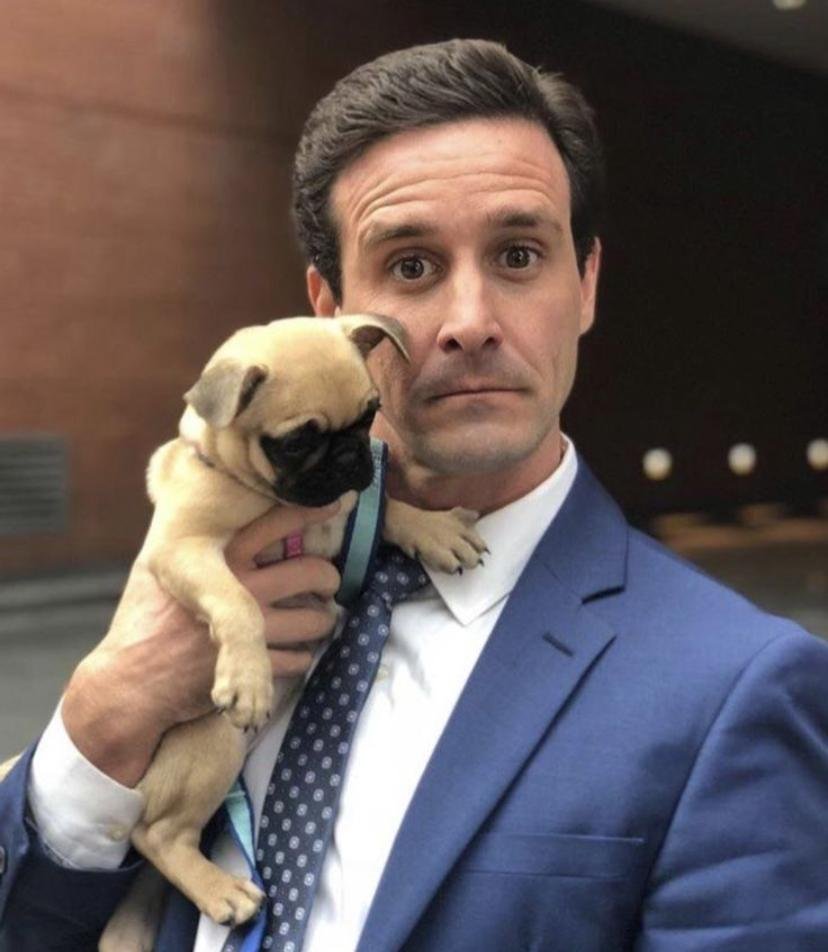 James Ransone coverage image showing the actor holding a small dog during a public appearance
